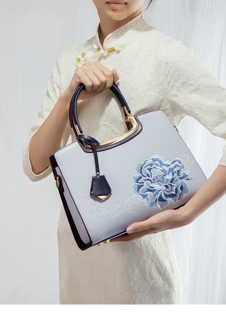 Ladies Elegant Burgundy Handbag with Floral Embroidery And Gold-Tone Hardware